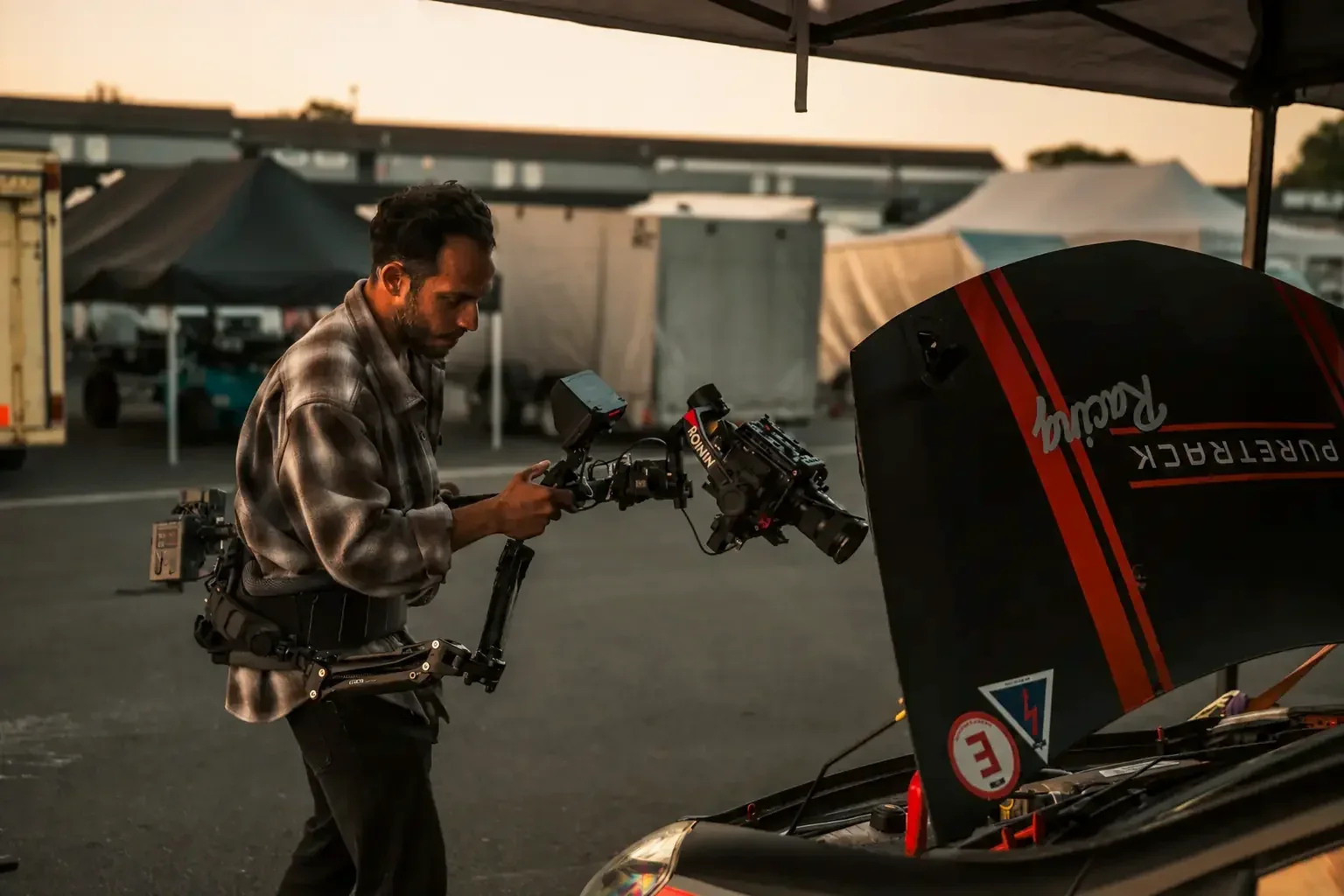 Camera operator filming a motorsport production with a stabilised cinema rig